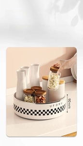Close-up of a rotating kitchen spice rack featuring a 90mm high guardrail for safe storage