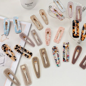 Flat lay detail of geometric acetate hair claws in leopard and marble patterns