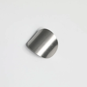 Macro detail of curved silver metal hair hook with a minimalist brushed finish