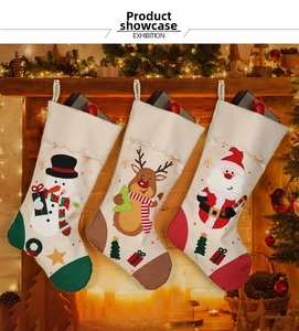 Three classic Christmas stockings with snowman, reindeer, and Santa motifs on fireplace