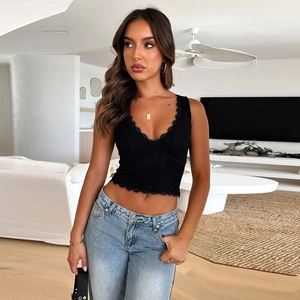 Lace trim V-neck crop top camisole for women paired with slim blue jeans in a modern living room