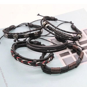 Macro shot of 5-piece retro black leather bracelet set with silver charms and beads