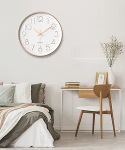 Detail of rose gold wall clock with 3D numerals and quartz movement on modern bedroom wall