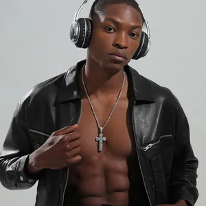 Hip hop style cross pendant necklace with clear zircons worn by a male model on a chain