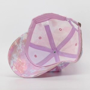 Detailed macro view of the interior lining and size tag of a colorful tie-dye kids cap