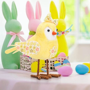 Close-up of yellow Easter chick figurine with floral patterns and soft plush texture
