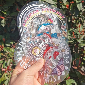Close-up of holographic PVC suncatcher stickers featuring mushroom and butterfly motifs