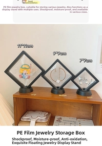 Set of three PE film floating jewelry display boxes in various sizes on a wooden shelf