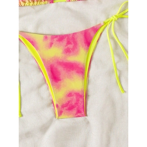 Detail of neon tie-dye bikini bottoms featuring adjustable side ties and vibrant colors