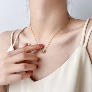 Elegant gold choker with rectangle zircon pendant worn on neck for a minimalist look