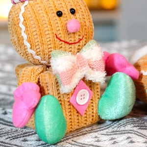 Detailed macro shot of gingerbread man ornament featuring corduroy texture and plush details