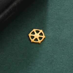 Detailed close-up of 18K gold-plated stainless steel ship wheel pendant charm on green background