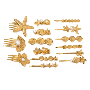 14-teiliges goldenes Haarspangen-Set mit Muscheln, Seesternen, Perlen und Strass auf Weiß