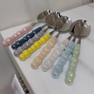 Close-up of stainless steel spoons with colorful ceramic bead handles in 8 vibrant tones