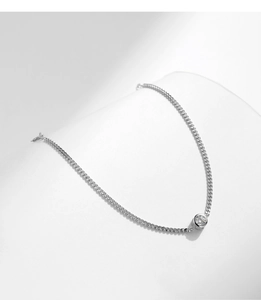 Macro shot of minimalist s925 silver chain bracelet featuring a round solitaire moissanite