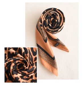 Close-up of silk scarf with classic brown leopard print and fine texture detail