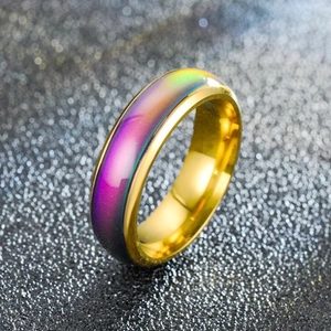 Macro shot of temperature color changing ring with gold edges and rainbow surface
