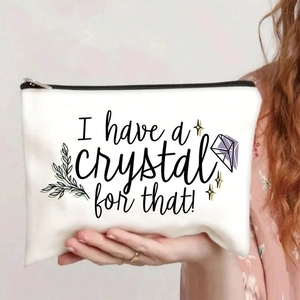 Detail of white canvas cosmetic bag with crystal print and secure black zipper closure