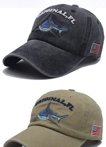 Detail of washed cotton baseball cap with shark embroidery and US flag patch