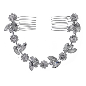 Close-up of handmade silver bridal hair combs with sparkling crystals and leaf motifs