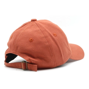 Rear view of cotton baseball cap in burnt orange with adjustable strap and metal buckle