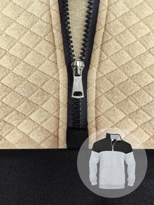 Detailed view of the diamond quilted pattern and silver zipper on the khaki contrast collar