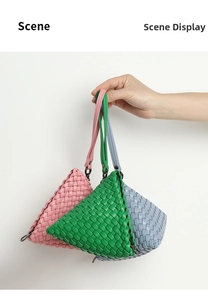 Close-up of three hand-woven triangular wristlet bags in pink, green, and blue hues