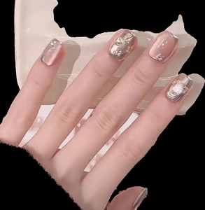 Handmade cat-eye press-on nails in champagne gold with 3D embossed texture and tiny rhinestones