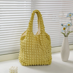 Minimalist yellow waffle texture tote bag with stylish bubble fabric design on white sill