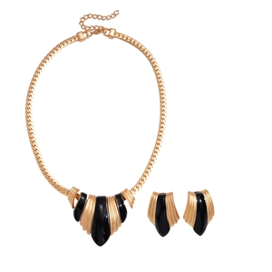 Golden irregular geometric necklace and earring set with black enamel detail