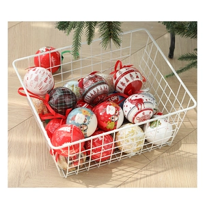 Close-up of festive Christmas ornaments with patterns in a white wire basket decoration