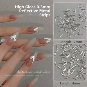 Macro shot of 0.5mm silver metal nail art strips in 4mm and 7mm lengths with application view