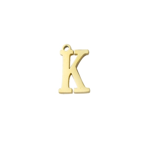 Macro detail of a mirror-polished golden stainless steel letter K pendant charm