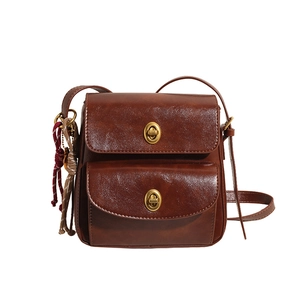 Brown vintage faux leather crossbody bag with double gold turn-lock clasps for women