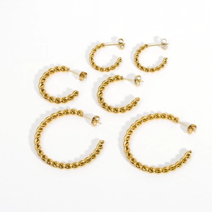 Three pairs of twisted gold C-shaped hoop earrings in small, medium, and large sizes