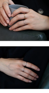 Detail of stacked geometric rhombic rings and minimalist gold bands on fingers