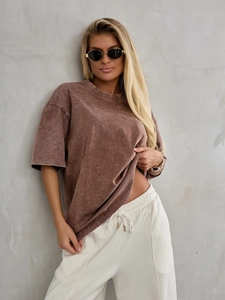 Detail of vintage washed dark brown cotton oversized T-shirt with heavy distressed texture