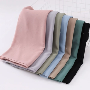 Multicolor pearl chiffon shawls with sparkling rhinestones in a white metal basket