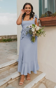 Close-up of light blue ruffle hem and flowing chiffon fabric on an elegant midi dress