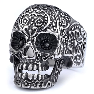 Macro shot of skull ring with intricate floral engraving and gothic punk silver finish