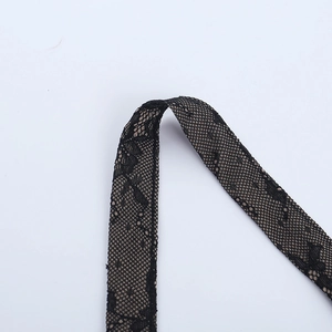 Close-up of black floral lace trim showing detailed hollow-out patterns and texture