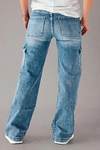 Macro detail of the light blue washed denim cargo pants with large flap side pockets