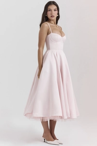 Detail of elegant pink satin midi dress with layered French mesh and a flowing silhouette