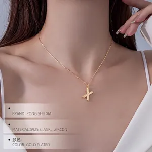 Elegant S925 sterling silver X letter pendant necklace with cubic zirconia on female neck