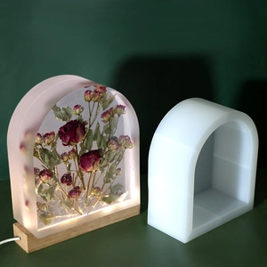 Macro view of DIY arch resin mold featuring glowing LED wooden base and dried rose inlay