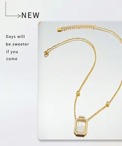 Detailed close-up of a gold stainless steel perfume bottle pendant with sparkling crystals