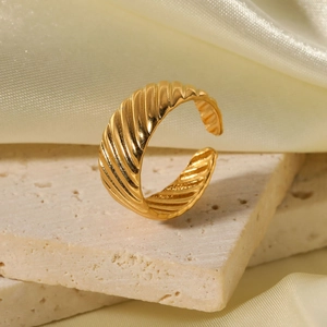Minimalist 18k gold plated stainless steel ribbed open ring on a textured stone