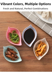 Leaf-shaped seasoning dishes in four colors on a wooden table with snacks