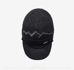 Detailed top view showing the dark grey wave knit texture and visor of the winter beanie