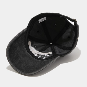 Close-up of the 100% cotton inner lining and metal adjustment buckle on a washed black cap